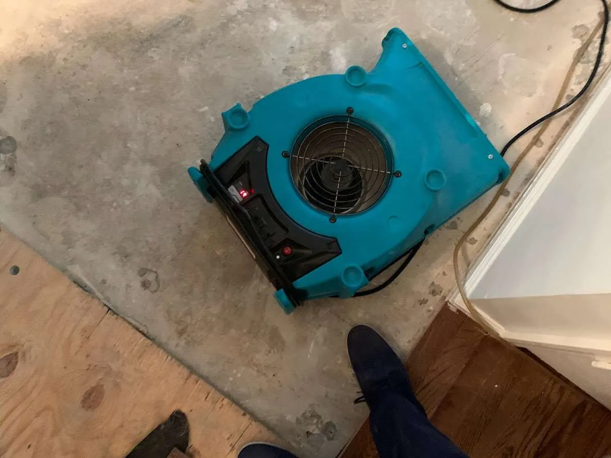 Air mover drying subfloor during Commercial Water Damage Restoration in Euclid